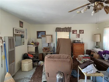 a living room with furniture and a dining room