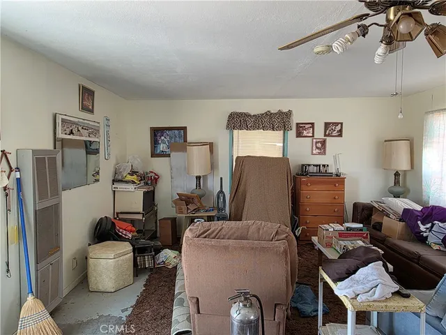 a living room with furniture and a dining room