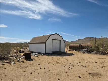 a view of a dry yard with a mountain