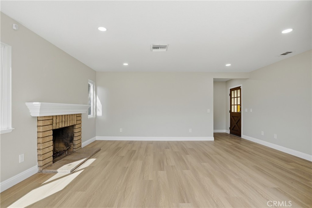 2924 Louisiana Place Riverside, CA 92506 - Photo 16 of 42 an empty room with wooden floor and fireplace