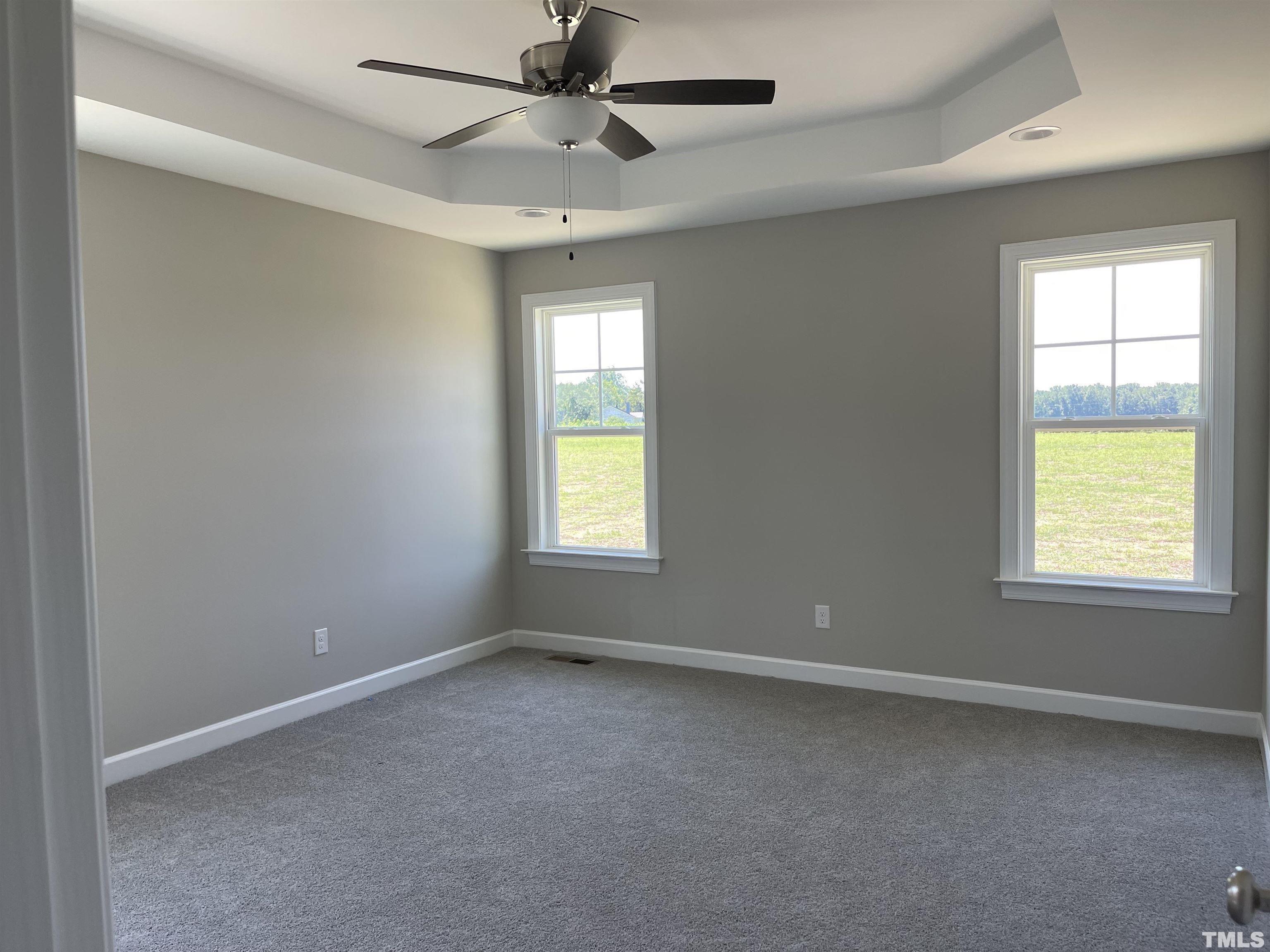 1171 Denning Road Angier, NC 27501 - Photo 7 of 8 an empty room with a window and a fan