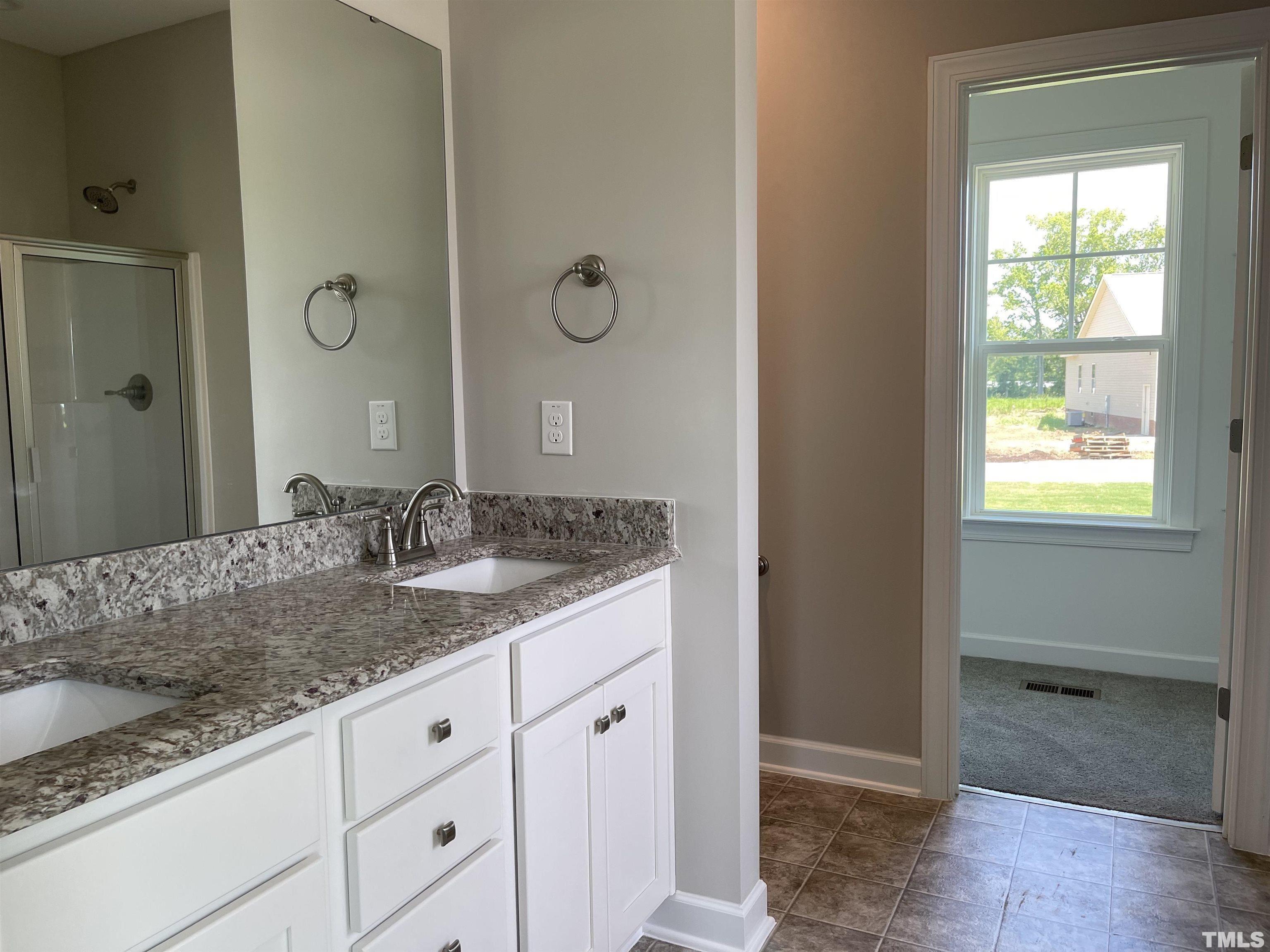 1171 Denning Road Angier, NC 27501 - Photo 8 of 8 a bathroom with a granite countertop sink and a mirror