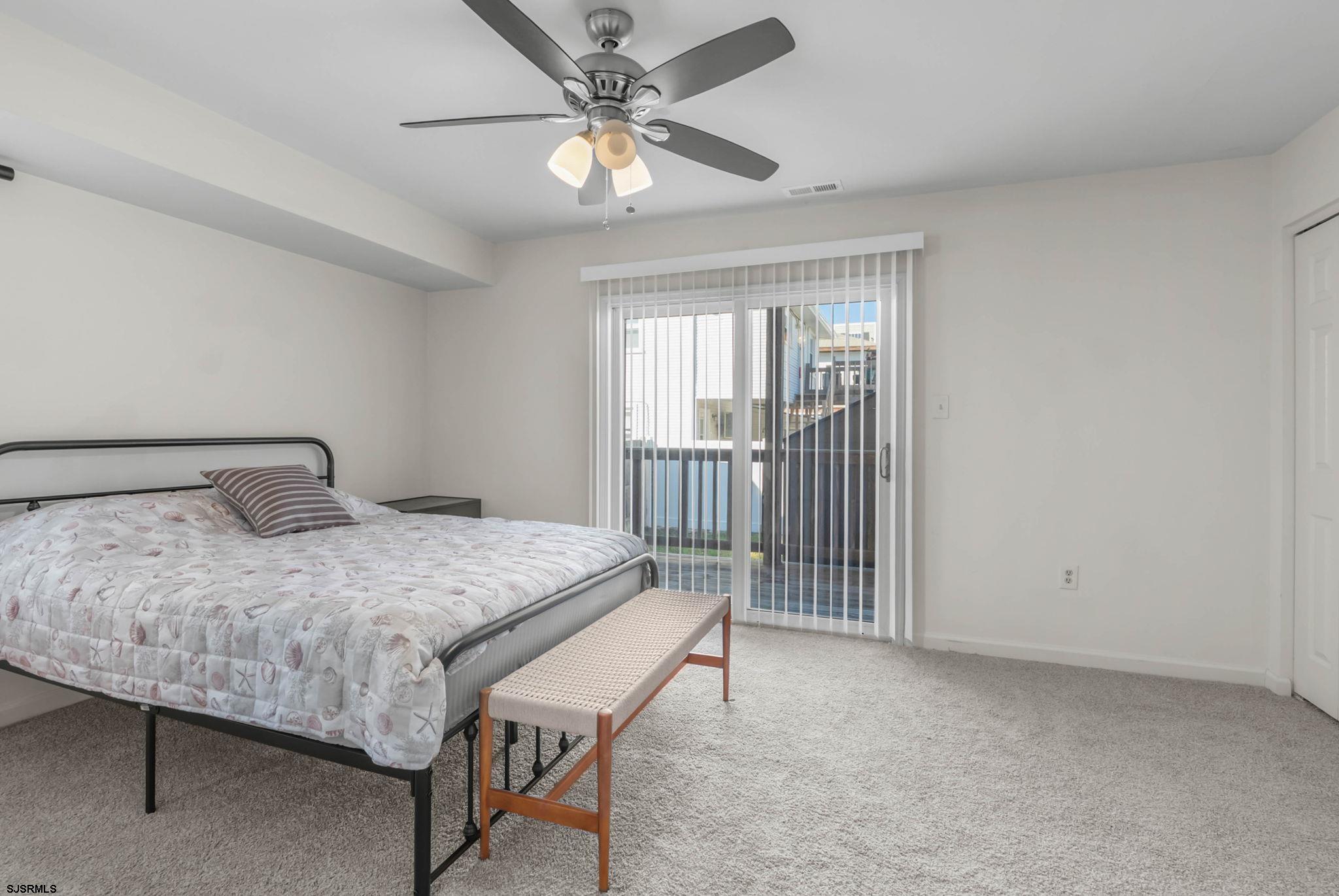 413 West Beach Avenue, Unit B Brigantine, NJ 08203 - Photo 11 of 30 a bedroom with a bed and a chandelier