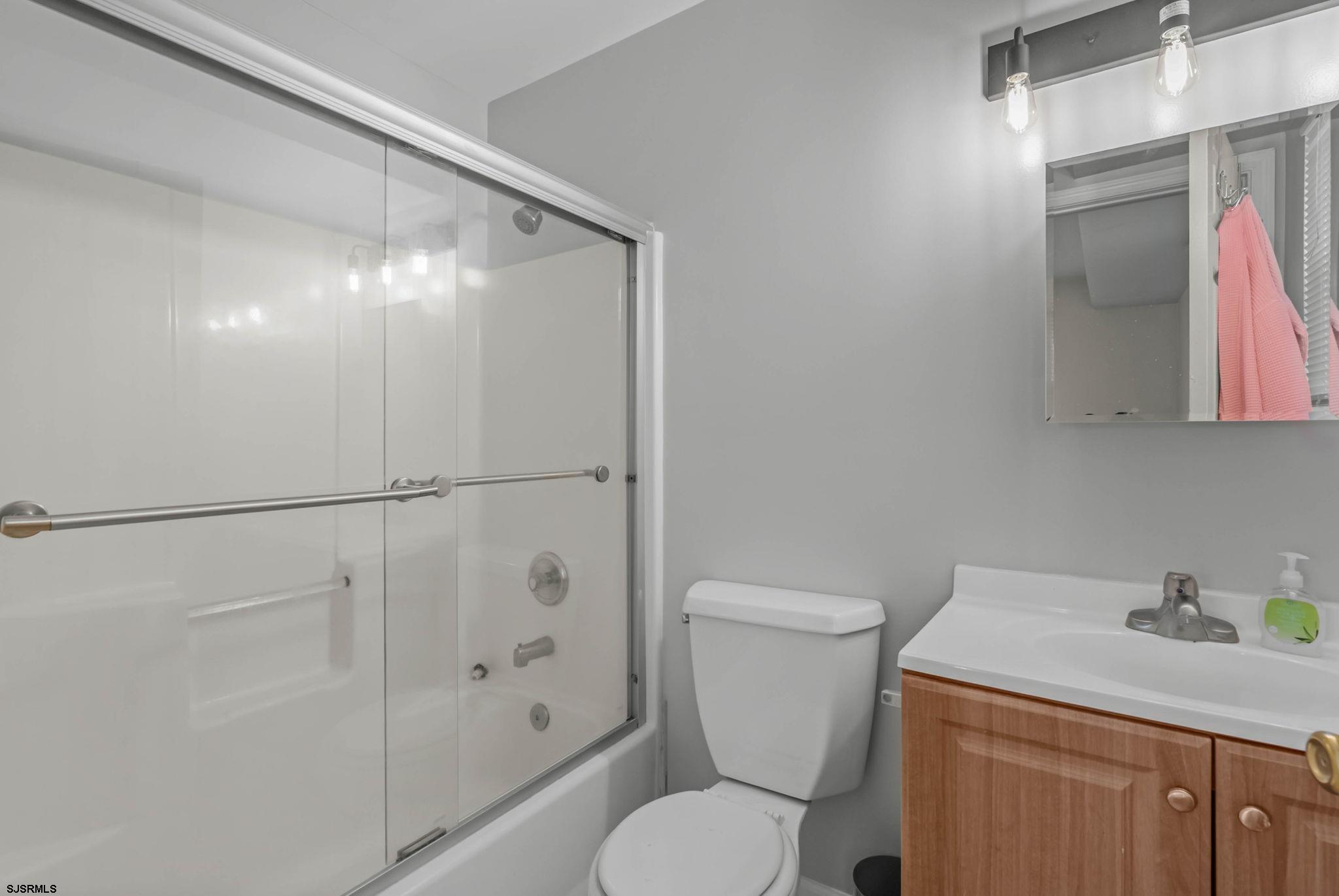 413 West Beach Avenue, Unit B Brigantine, NJ 08203 - Photo 13 of 30 a white toilet sitting next to a bathroom sink