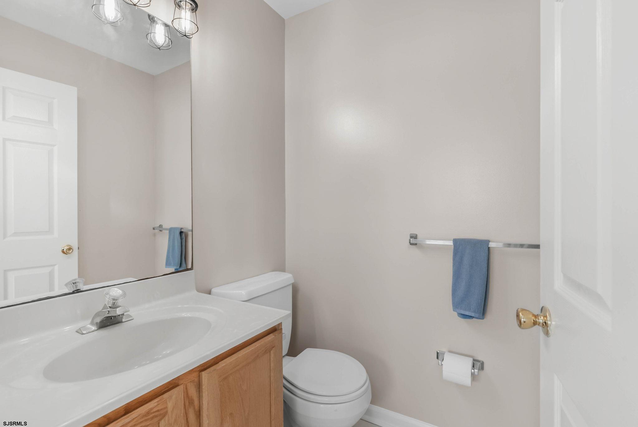 413 West Beach Avenue, Unit B Brigantine, NJ 08203 - Photo 22 of 30 a bathroom with a sink vanity mirror and toilet