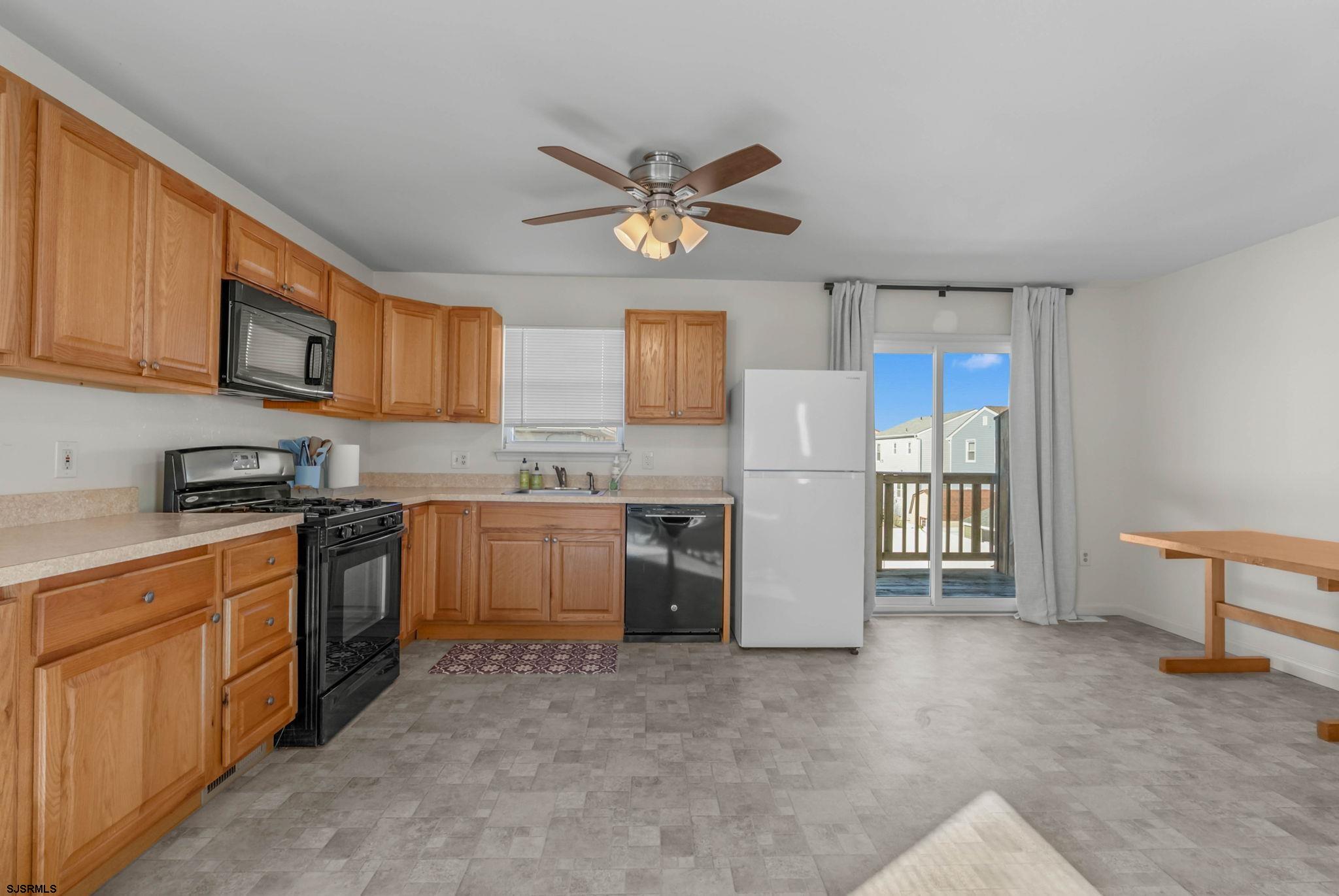 413 West Beach Avenue, Unit B Brigantine, NJ 08203 - Photo 23 of 30 a kitchen with stainless steel appliances granite countertop a refrigerator sink and stove