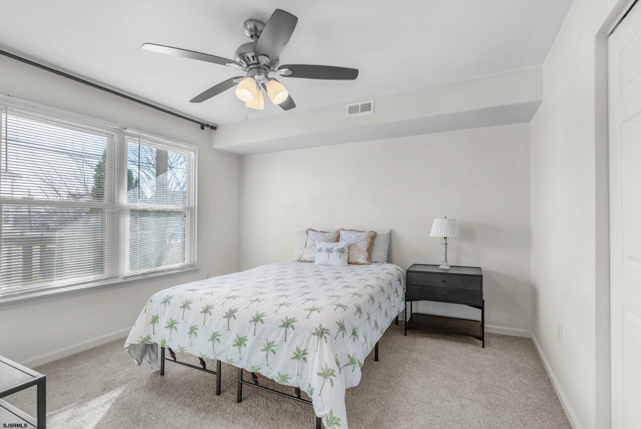 413 West Beach Avenue, Unit B Brigantine, NJ 08203 - Photo 6 of 30 a bedroom with a bed and window
