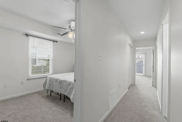 a view of room with window and a ceiling fan