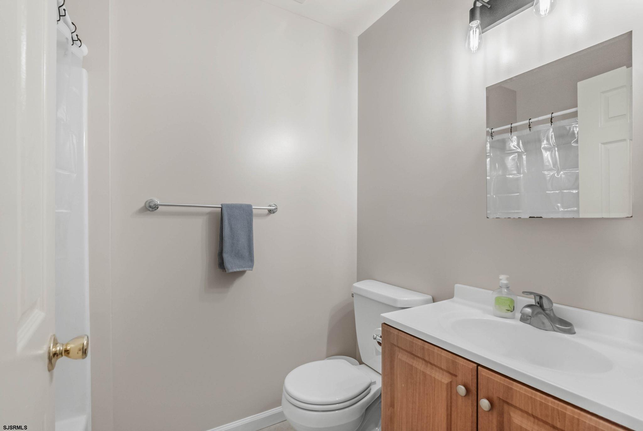 413 West Beach Avenue, Unit B Brigantine, NJ 08203 - Photo 9 of 30 a bathroom with a sink toilet and vanity
