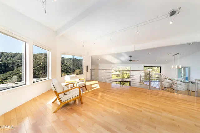 a living room with furniture and large windows