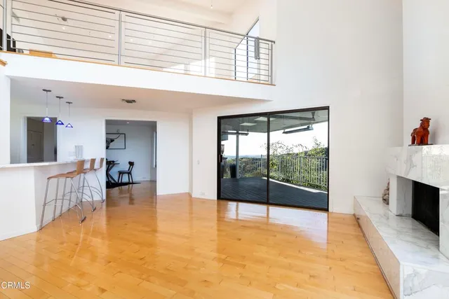 a view of an empty room and kitchen