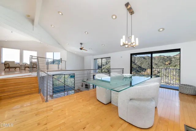 a dining hall with stainless steel appliances granite countertop a granite counter tops and a view of living room