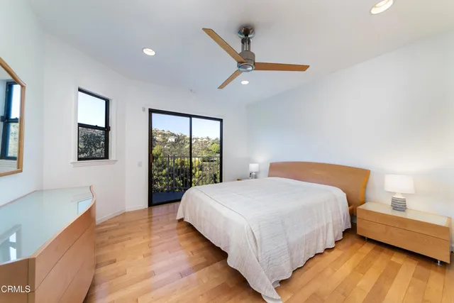 a bedroom with a large bed and a window