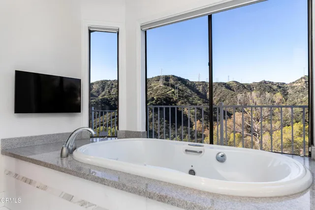 a bath tub sitting next to a window