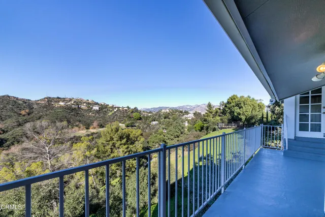 a view of a balcony with wooden fence