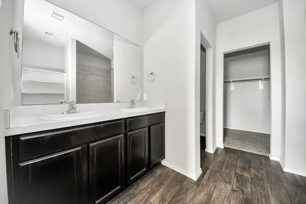 a bathroom with a double vanity sink and mirror