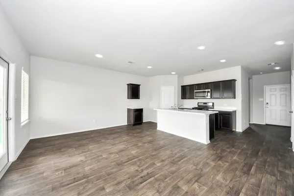 a view of kitchen with cabinets microwave and stove
