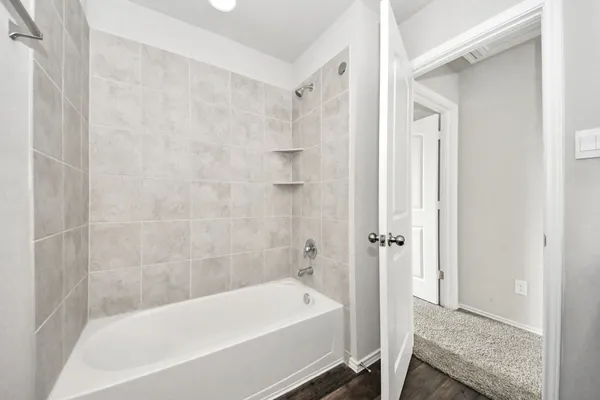 a bathroom with a bathtub and shower