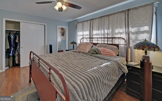 a bedroom with a large bed and a chandelier