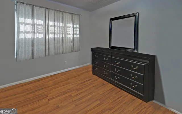 a room with a dresser with wooden floor