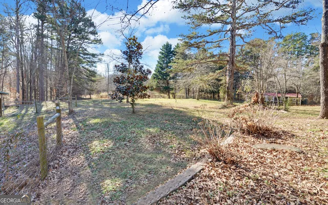 a view of dirt yard with a tree