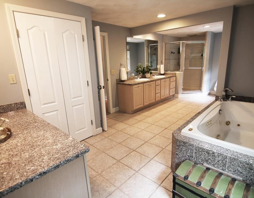 4 Paddock Lane Lexington, MA 02421 - Photo 16 of 25 a bathroom with a tub sink and mirror
