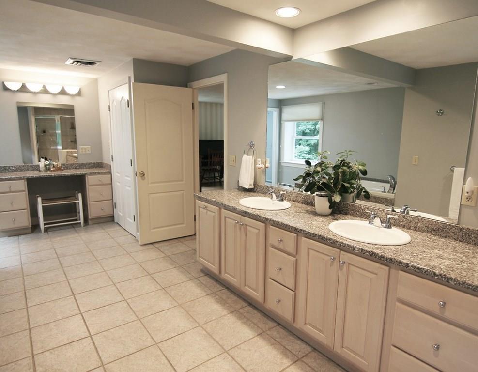4 Paddock Lane Lexington, MA 02421 - Photo 17 of 25 a spacious bathroom with a granite countertop sink and a mirror