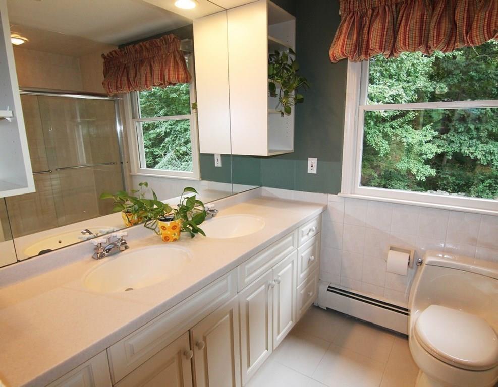 4 Paddock Lane Lexington, MA 02421 - Photo 19 of 25 a bathroom with a sink a toilet and a window