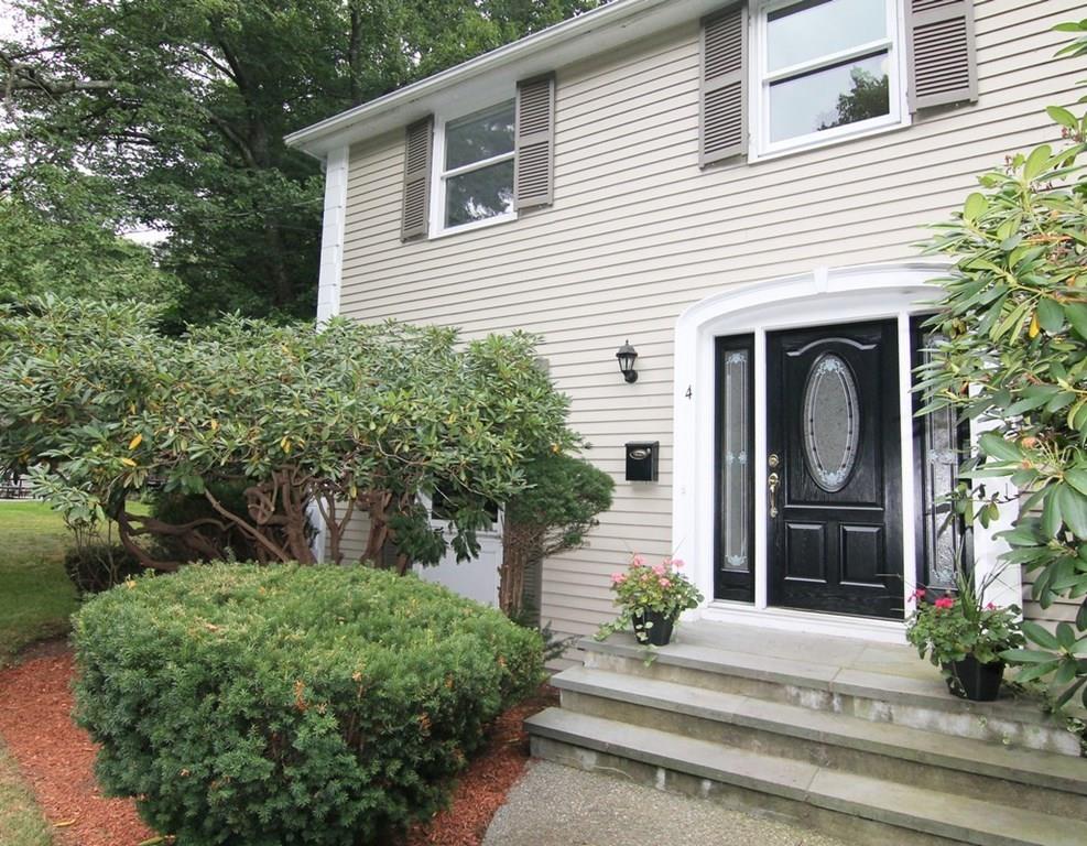 4 Paddock Lane Lexington, MA 02421 - Photo 2 of 25 a front view of a house with garden