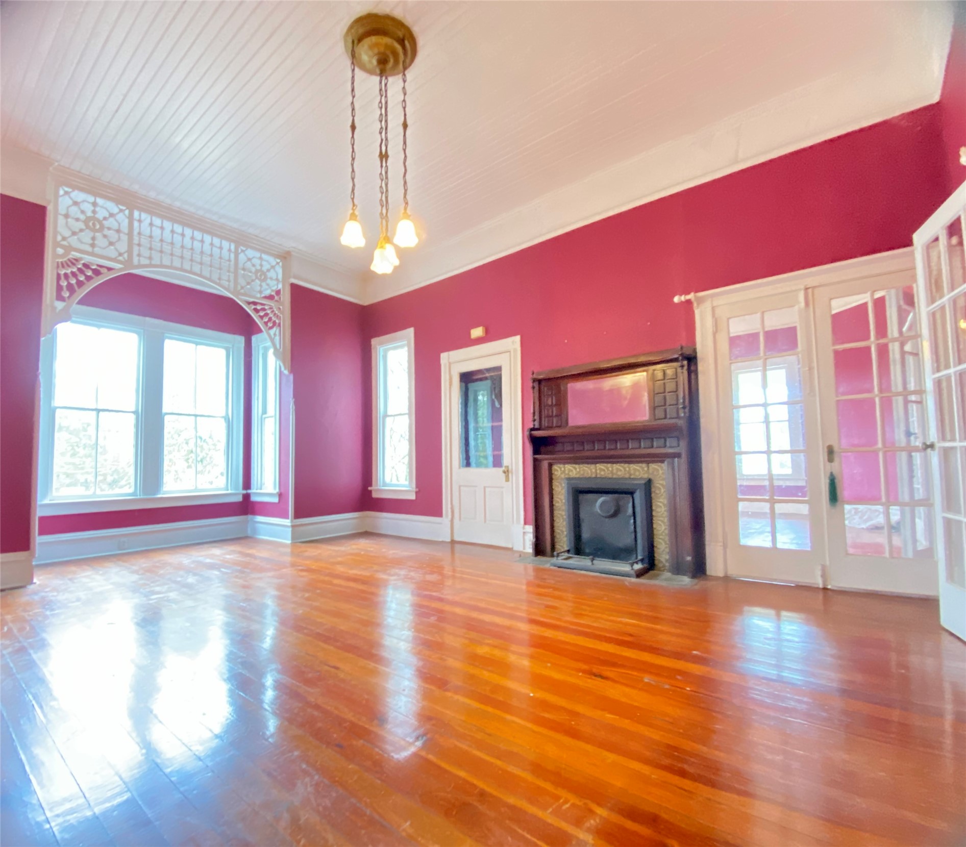 223 East Robert Toombs Avenue Washington, GA 30673 - Photo 14 of 46 a view of an empty room with wooden floor fireplace and a window