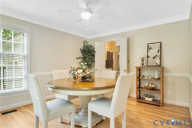 a view of a dining room with furniture and wooden floor