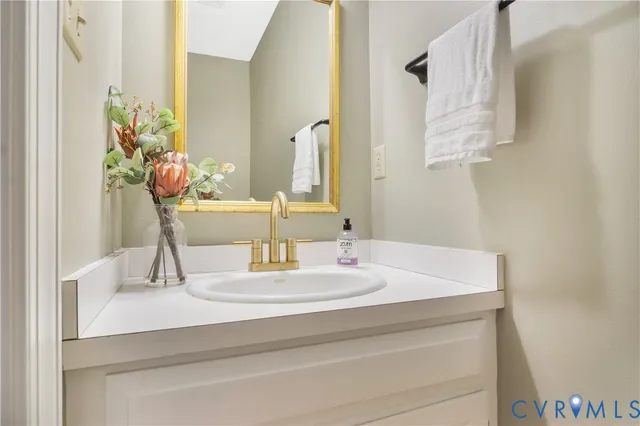 a bathroom with a sink vanity and a mirror