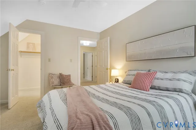 a bedroom with a bed and a painting on the wall