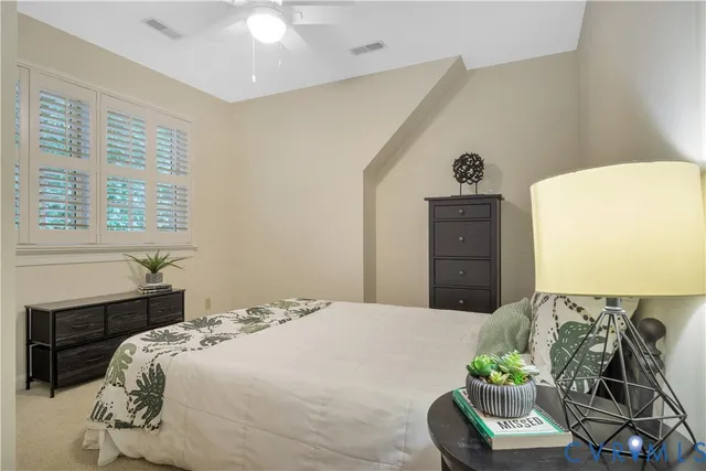 a bedroom with a bed and ceiling fan
