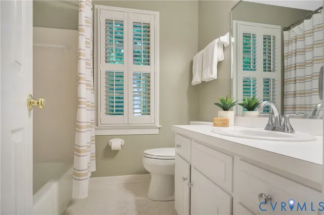a bathroom with a sink a toilet and a window