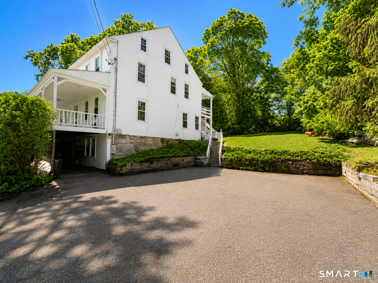 443 Amity Road Bethany, CT 06524 - Photo 3 of 30 a front view of a house with a yard and garage