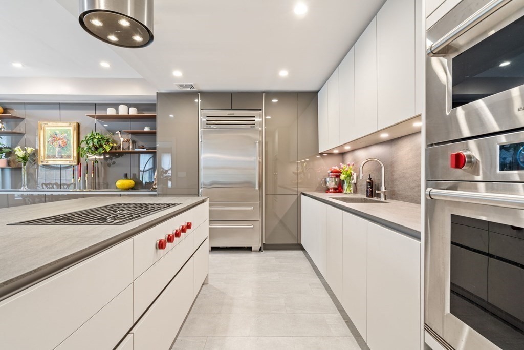 a kitchen with stainless steel appliances granite countertop a stove and a refrigerator
