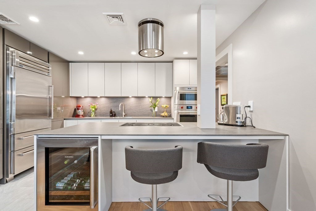 135 Beaconsfield Road, Unit 2 Brookline, MA 02445 - Photo 14 of 33 a kitchen with stainless steel appliances granite countertop a sink and a refrigerator