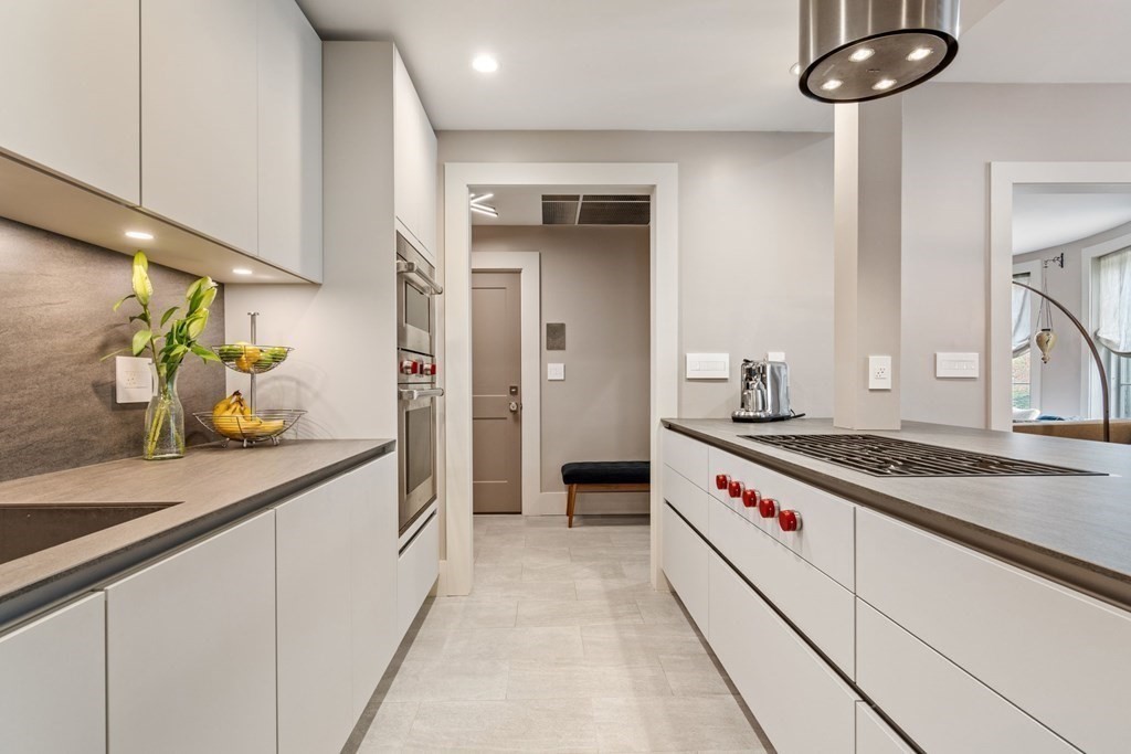 135 Beaconsfield Road, Unit 2 Brookline, MA 02445 - Photo 17 of 33 a kitchen with stainless steel appliances granite countertop a sink and cabinets