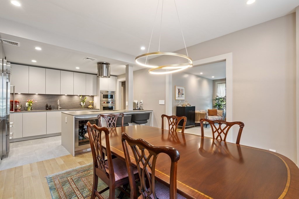135 Beaconsfield Road, Unit 2 Brookline, MA 02445 - Photo 18 of 33 a kitchen with a dining table chairs and white cabinets