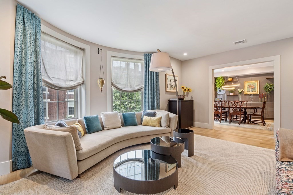 135 Beaconsfield Road, Unit 2 Brookline, MA 02445 - Photo 20 of 33 a living room with furniture a fireplace and a large window
