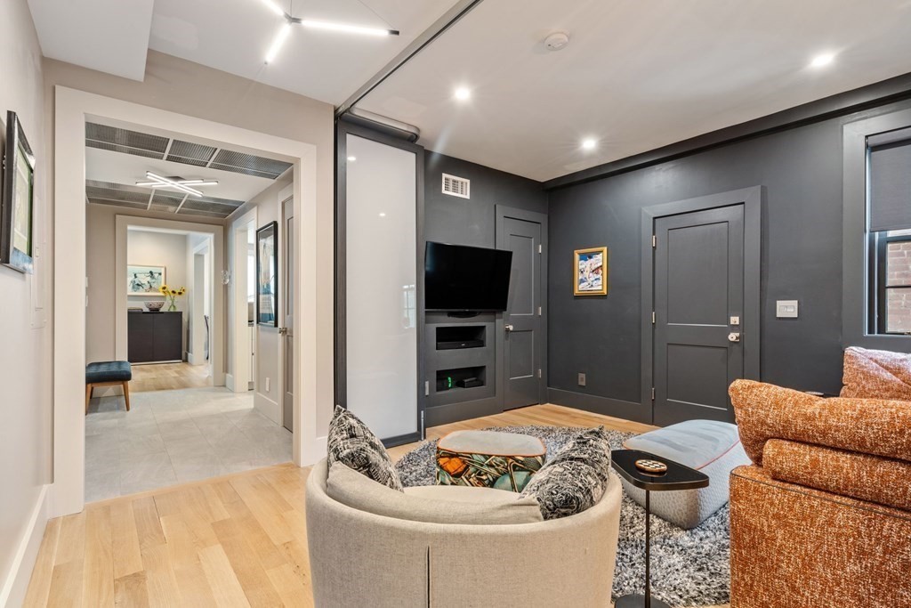 135 Beaconsfield Road, Unit 2 Brookline, MA 02445 - Photo 22 of 33 a living room with furniture and a flat screen tv