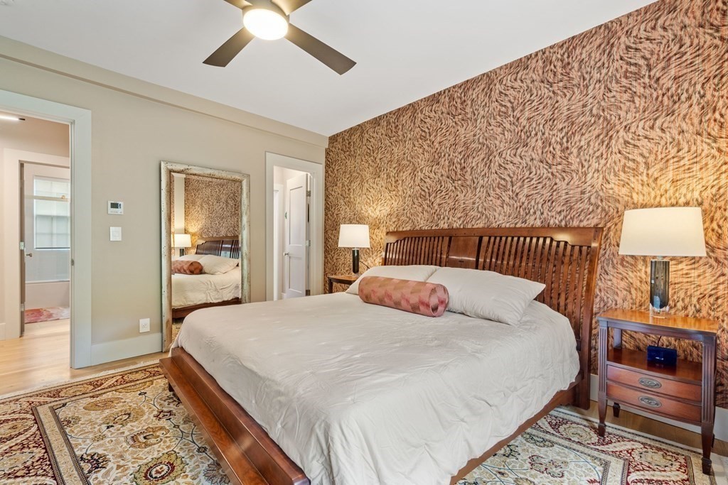 135 Beaconsfield Road, Unit 2 Brookline, MA 02445 - Photo 26 of 33 a bedroom with a bed and a chandelier