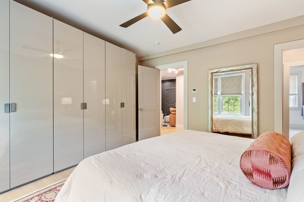 135 Beaconsfield Road, Unit 2 Brookline, MA 02445 - Photo 28 of 33 a bedroom with a large bed and a chandelier fan