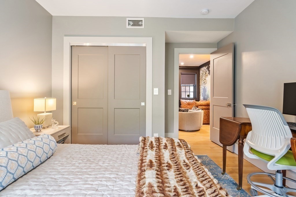 135 Beaconsfield Road, Unit 2 Brookline, MA 02445 - Photo 30 of 33 a bedroom with a bed and a mirror