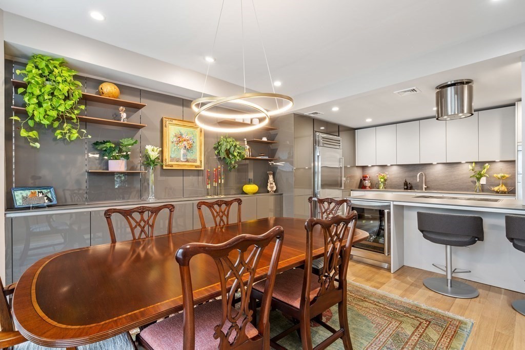 135 Beaconsfield Road, Unit 2 Brookline, MA 02445 - Photo 3 of 33 a kitchen with a table chairs and a wooden floor
