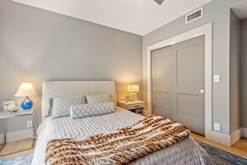 135 Beaconsfield Road, Unit 2 Brookline, MA 02445 - Photo 31 of 33 a bedroom with a bed and wooden floor