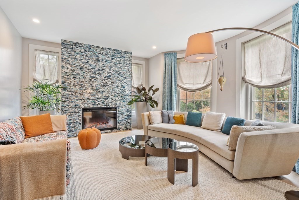 135 Beaconsfield Road, Unit 2 Brookline, MA 02445 - Photo 5 of 33 a living room with furniture a fireplace and a large mirror