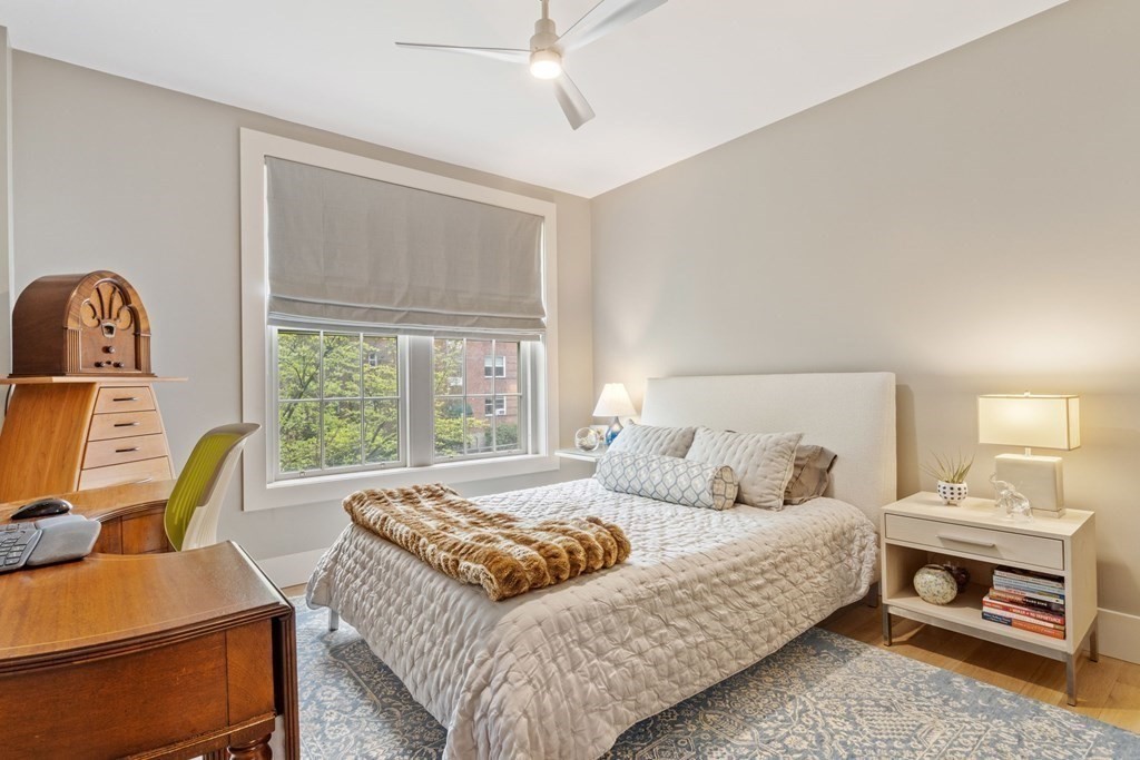 135 Beaconsfield Road, Unit 2 Brookline, MA 02445 - Photo 8 of 33 a bedroom with a bed and wooden floor