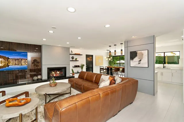 a kitchen with a table chairs stove and kitchen view